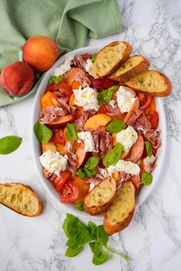 Peach and Heirloom Tomato Caprese with Prosciutto, Burrata, Basil, and Grilled Garlic Toast